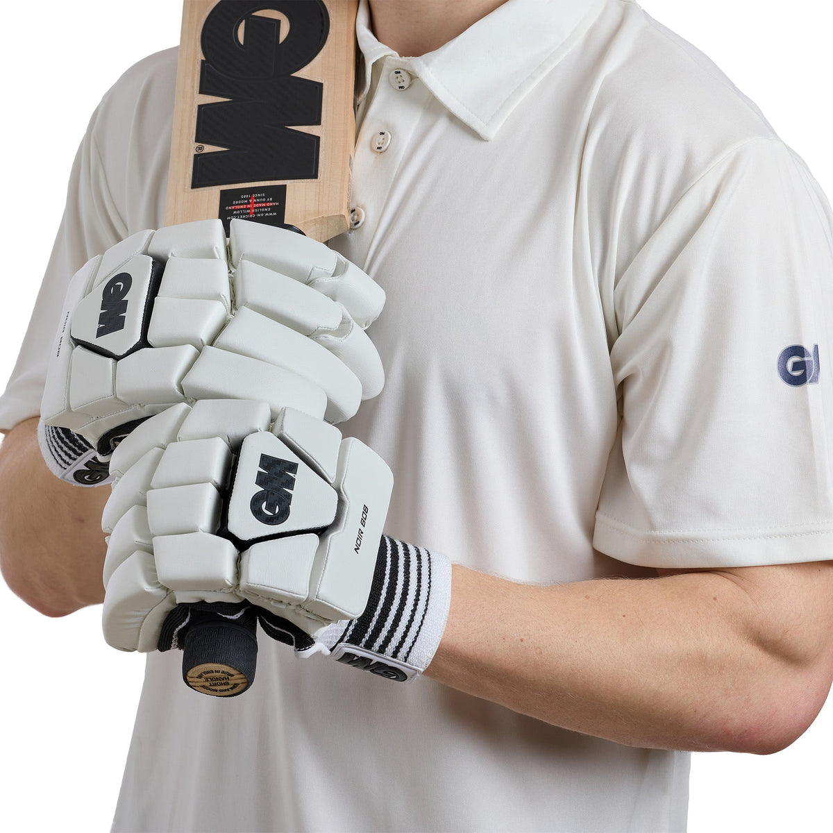GM Noir 808 batting gloves gripping a cricket bat handle showing the soft leather palm